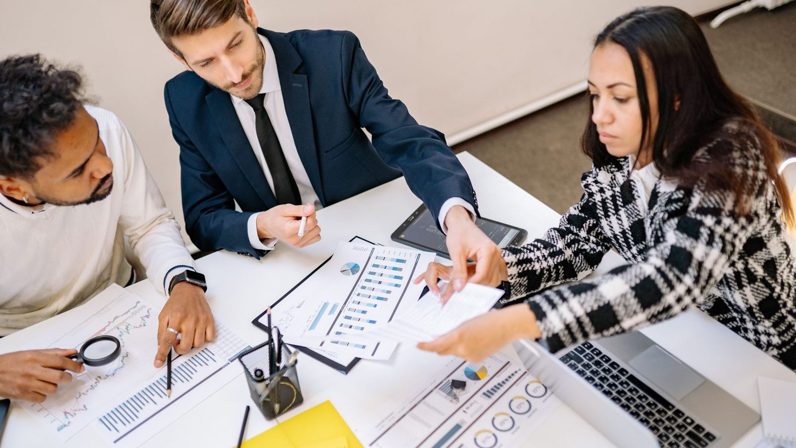 Marketing team reviewing a campaign plan on a laptop