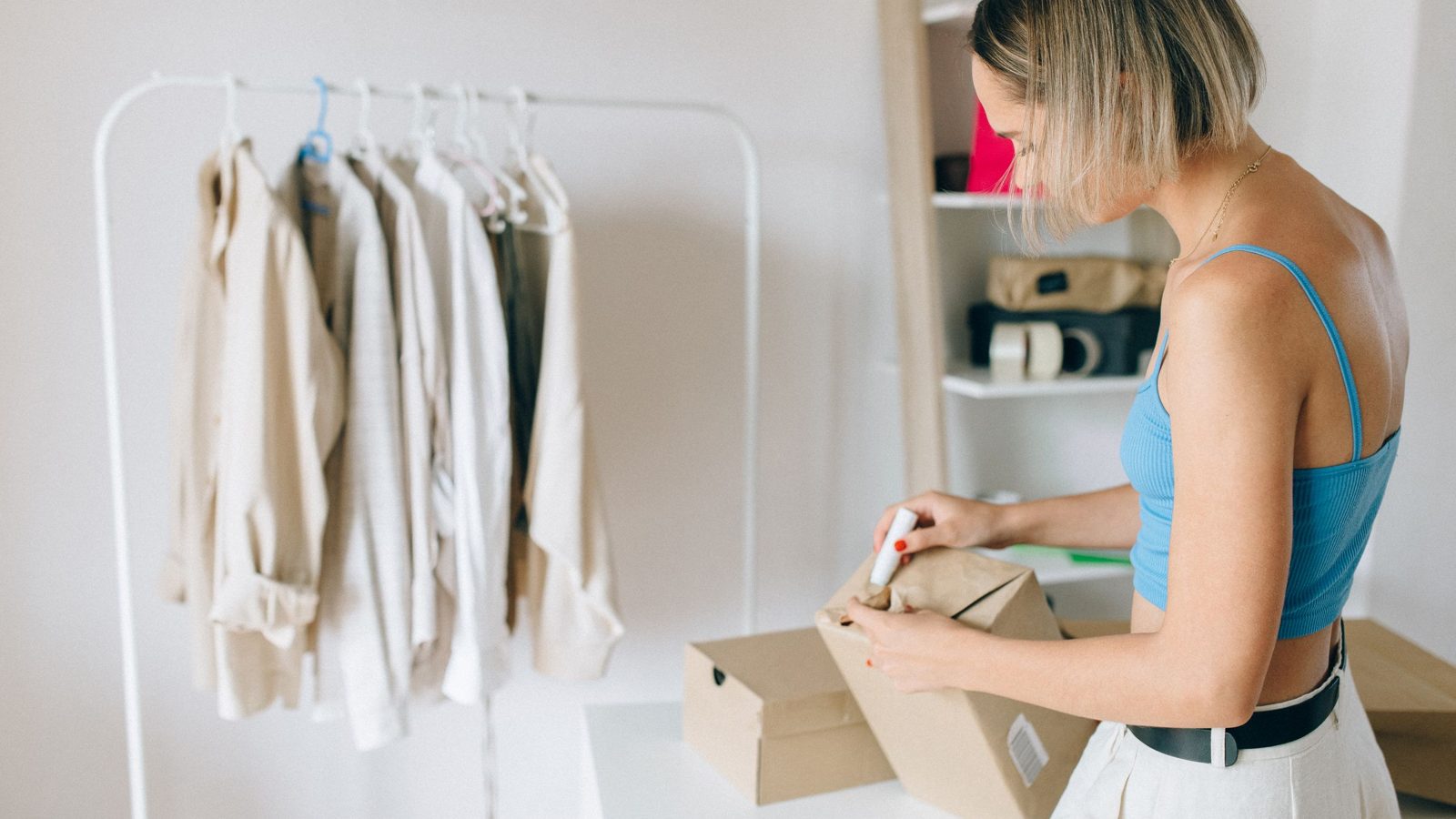 An online shop owner packing a parcel with a product